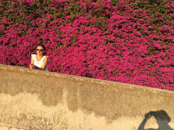 Portrait of young woman with pink petals
