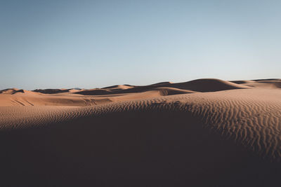 Scenic view of desert against clear sky