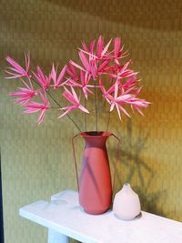 Close-up of red flower vase on table