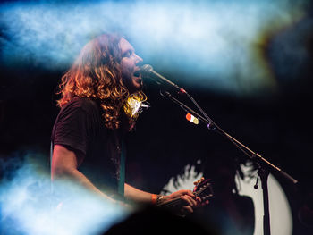 Man playing guitar at music concert