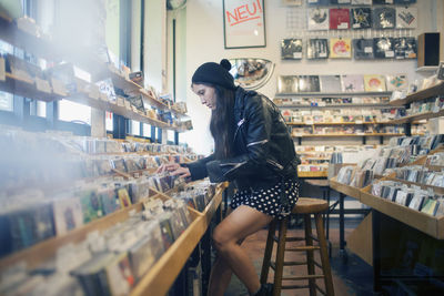 Side view of woman looking at store