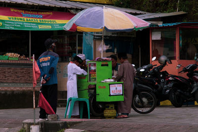 Rear view of people walking on street