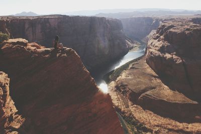 Scenic view of woman sitting atop grand canyon national park