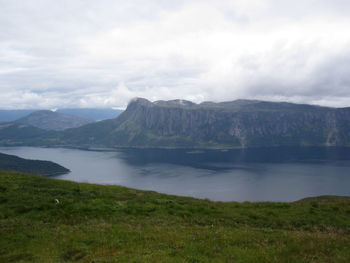 Scenic view of lake and mountains against sky