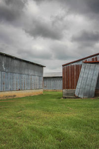 Barn on field against sky