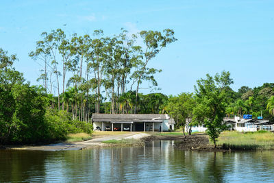 Building by river against sky