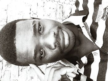 Close-up portrait of young man against wall