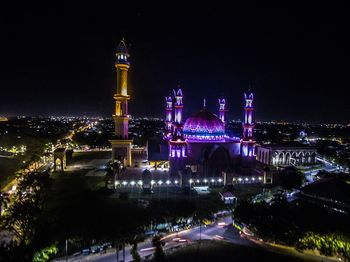 High angle view of illuminated lombok masjid amidst cityscape at night