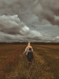 Woman on field against sky