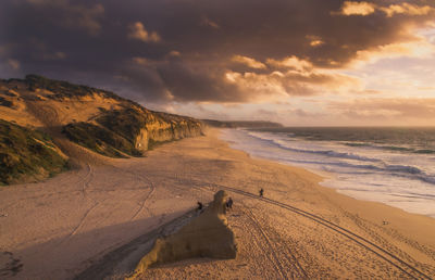 Scenic view of beach against sky during sunset