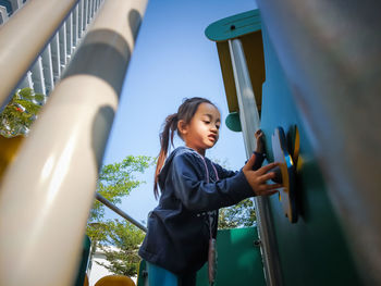 Asian little girl on the playground in the morning.