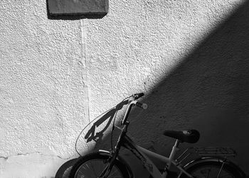 Bicycle leaning against wall