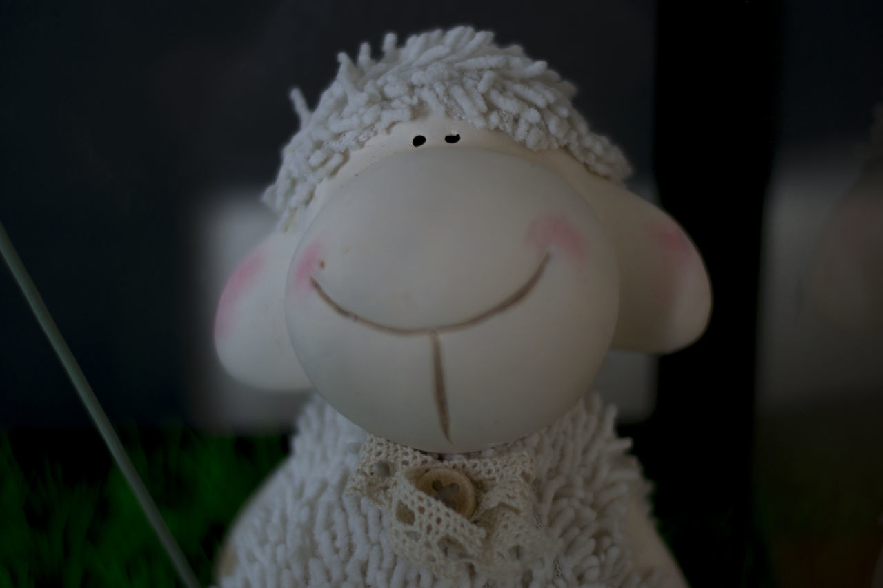 indoors, white color, close-up, focus on foreground, animal representation, still life, toy, stuffed toy, human representation, white, front view, no people, selective focus, art, table, creativity, home interior, art and craft, single object, humor