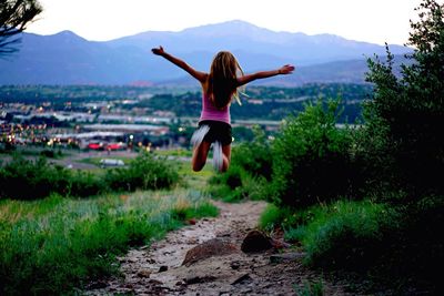 Woman jumping on landscape