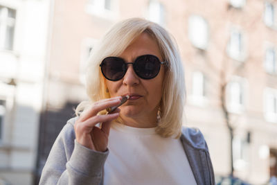 Portrait of young woman wearing sunglasses