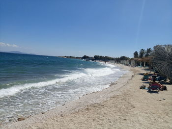 Scenic view of beach against blue sky