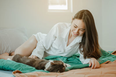 Young woman lying down on bed