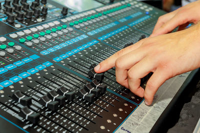 Close-up of cropped hands using sound mixer