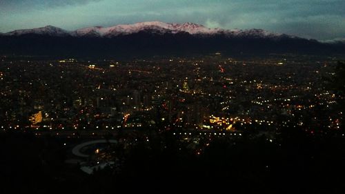 Aerial view of illuminated city at night