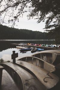 Boats moored in lake against sky