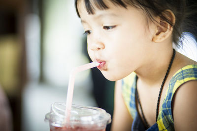 Close-up of girl drinking glass