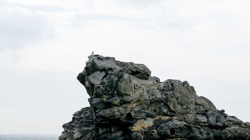 Low angle view of rock against sky