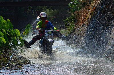 Man riding motorcycle on water