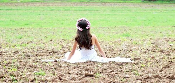 Rear view of girl looking at grassy field