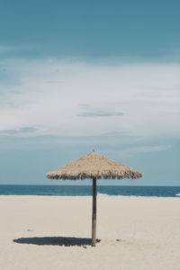 Lifeguard hut on beach against sky