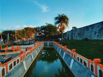 Bridge over canal against sky
