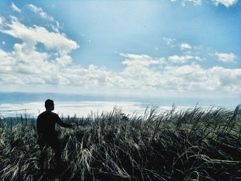 Man looking at sea against sky