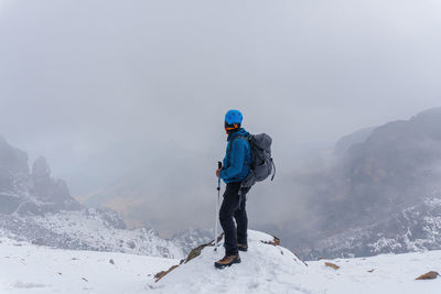 Full length of man standing on snow covered land