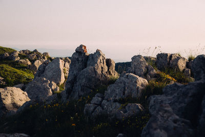 Rock formations on landscape against sky