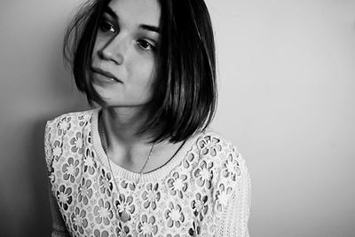 Portrait of beautiful young woman over white background