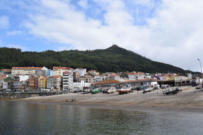 Town by buildings in city against sky