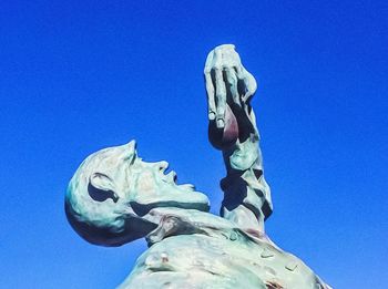 Low angle view of statue against clear blue sky