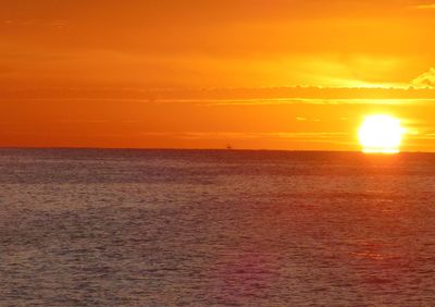 Scenic view of sea against romantic sky at sunset