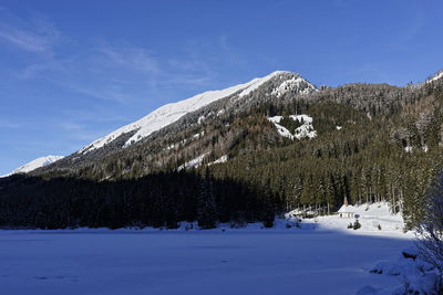 Snow covered landscape against sky