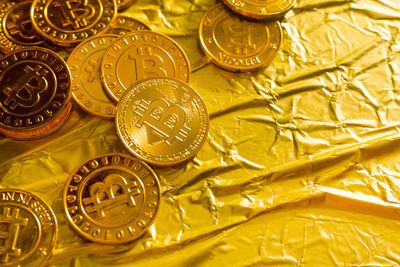 Close-up of bitcoins on golden paper