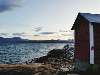 Scenic view of sea and houses against sky