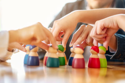 Close-up of hands playing with people