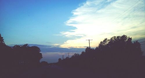 Silhouette trees against sky during sunset