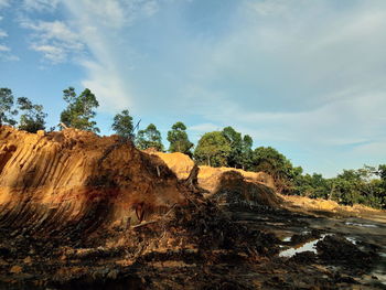 Panoramic view of rocks on landscape against sky