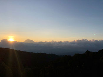 Scenic view of silhouette mountains against sky during sunset