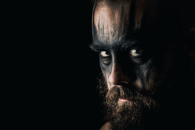 Portrait of a viking warrior with black war paint