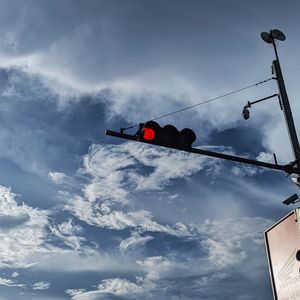 Low angle view of road sign against sky