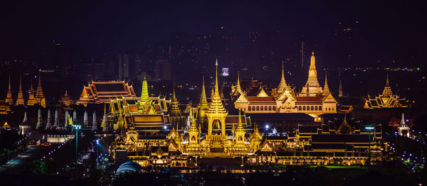 Illuminated temple against sky at night