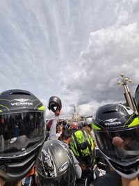 Panoramic view of people and cars against sky