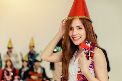 Portrait of smiling young woman in hat