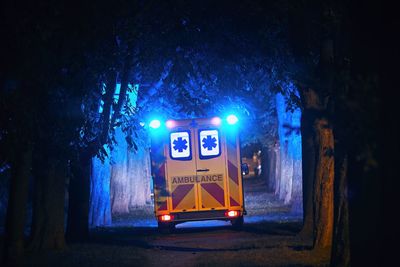 Rear view of ambulance on street at night
